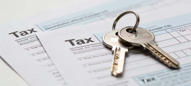 Deux clés brillantes posees sur documents fiscaux blancs.