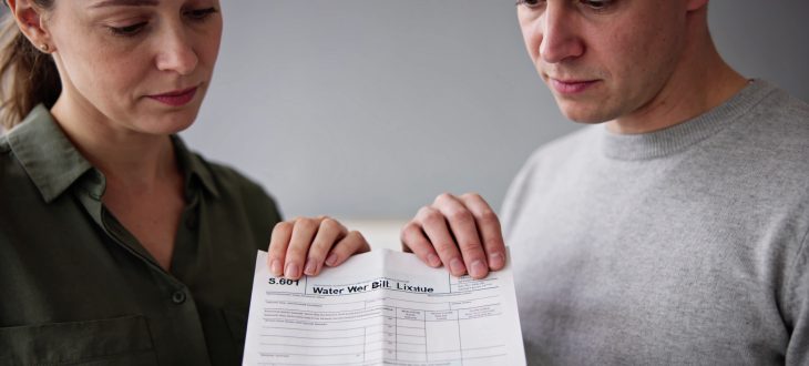 Deux personnes consultant une facture d'eau papier ensemble